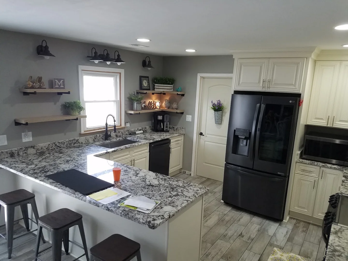 Updated kitchen with light cabinetry and stone counters