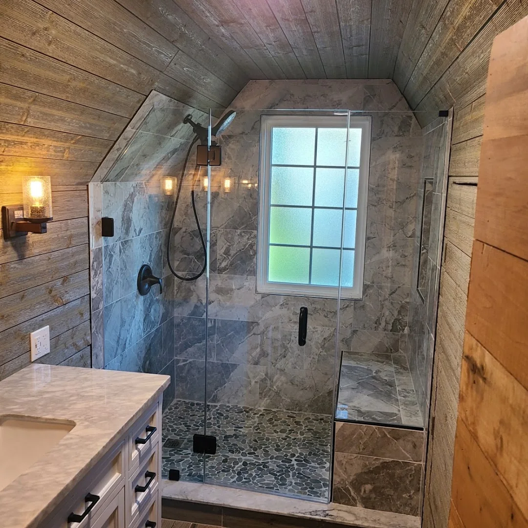 Tiled walk-in shower with glass door